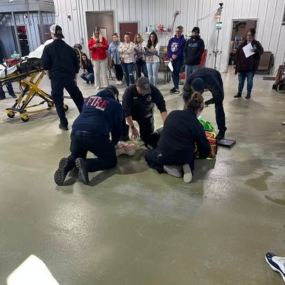 A group of people are kneeling on the floor in a room.