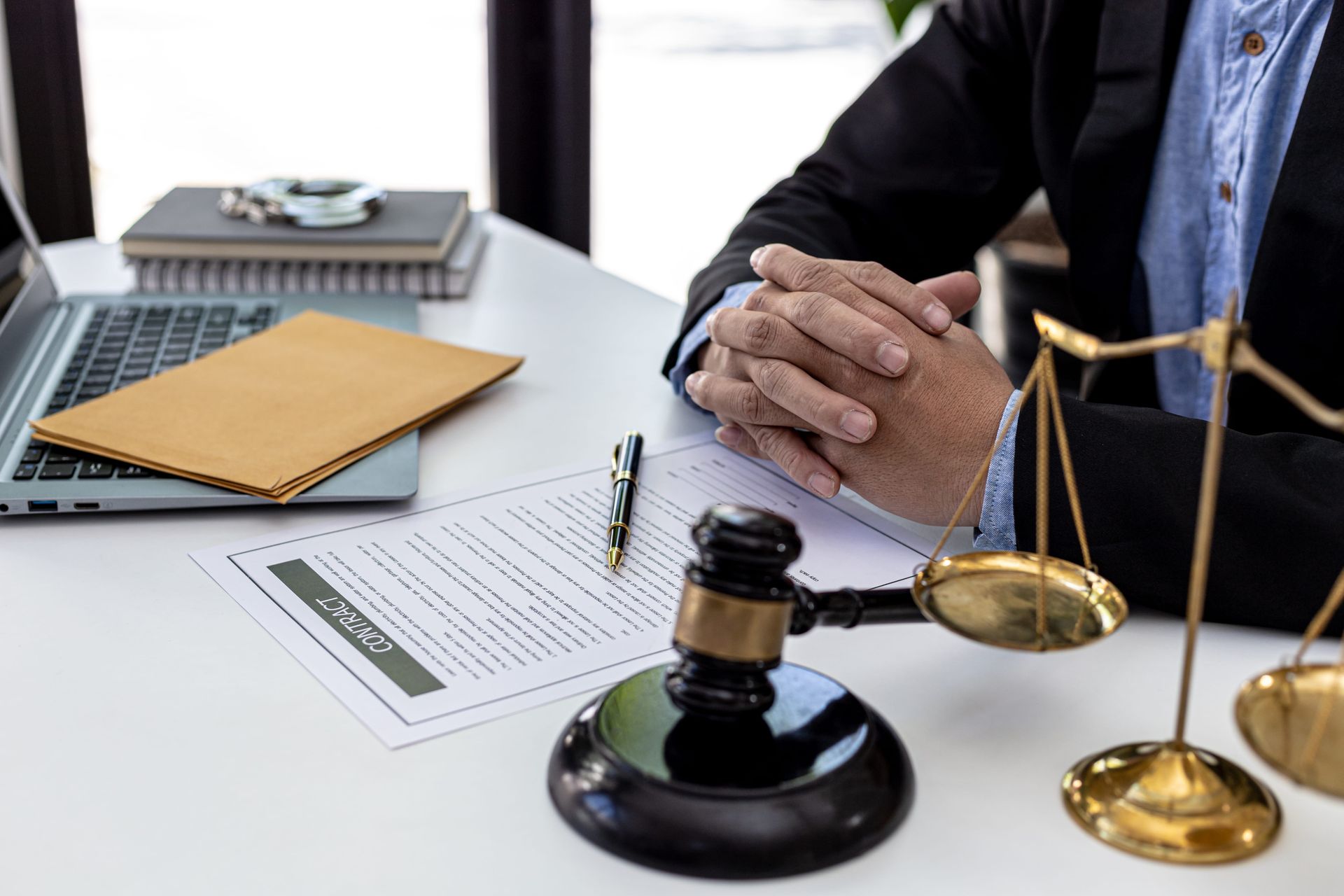 Lawyer's desk with gavel, scales of justice, paperwork, and a person in a suit