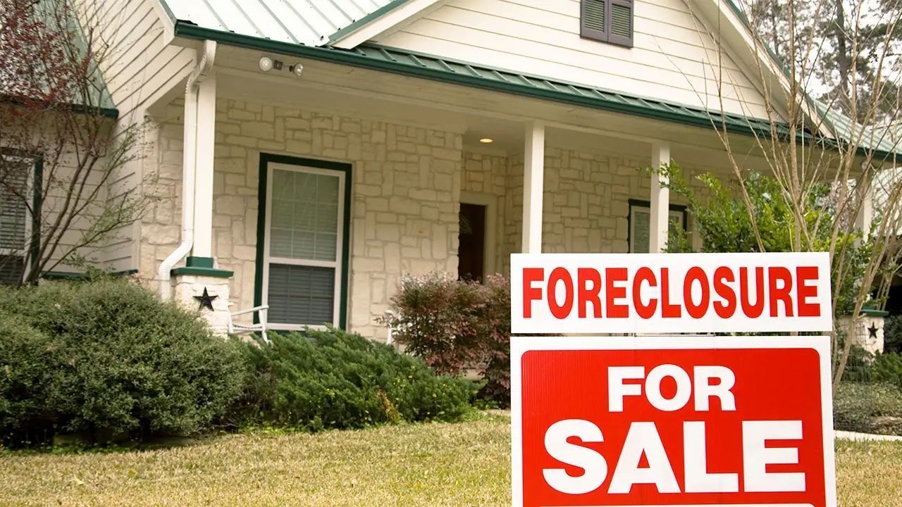 A house with a foreclosure sign in front of it.