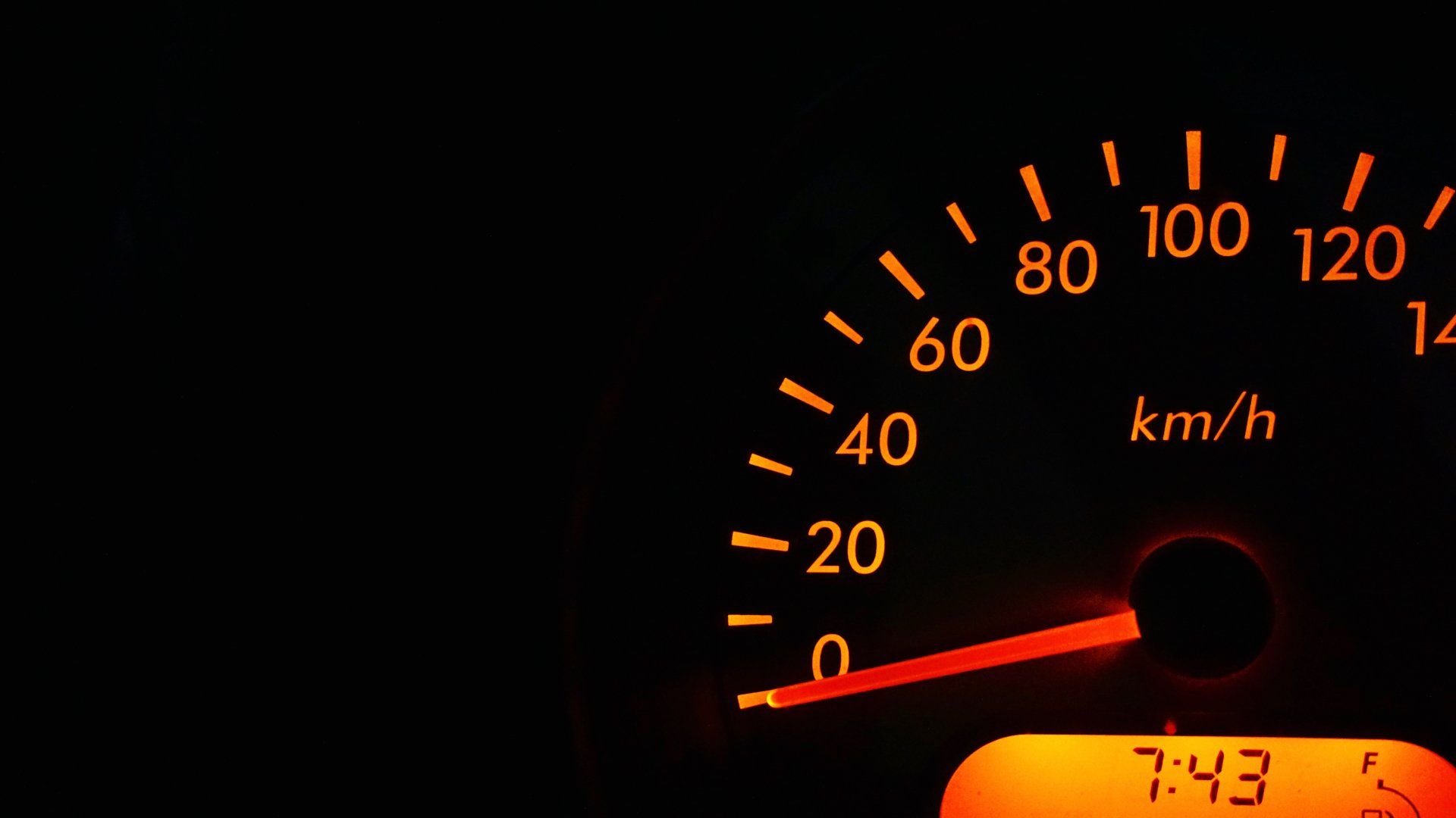 A close up of a speedometer that says 7:43 on it.