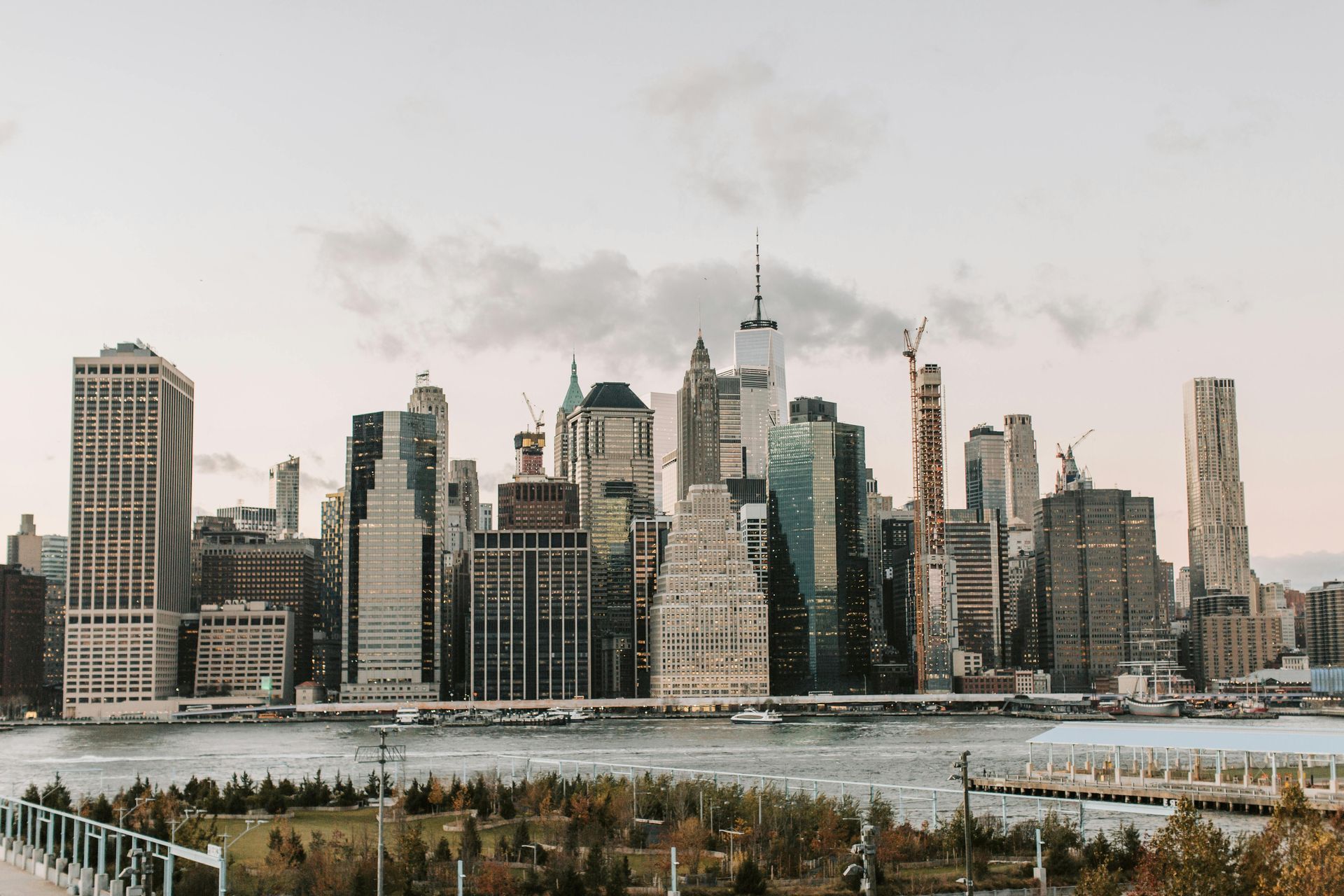 A city skyline with a river in the foreground.