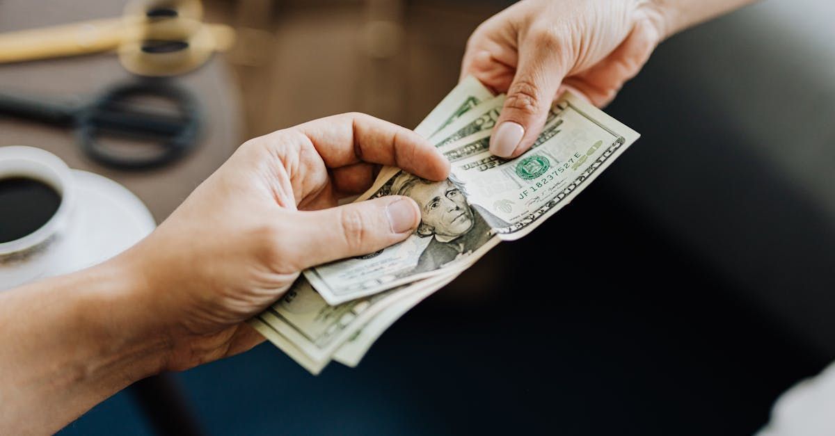 A person is handing another person a bunch of money.
