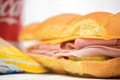 A ham and cheese sandwich on a bun