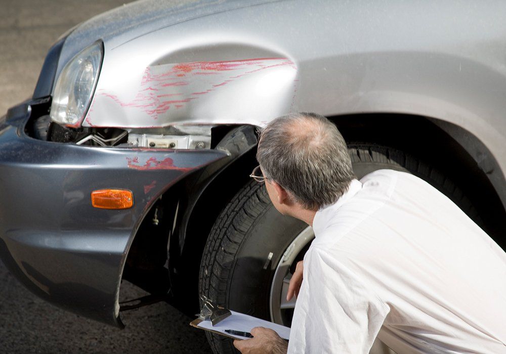 Insurance Adjuster Inspects the Damage to a Car — Weston, FL — All Lines Insurance Inc.