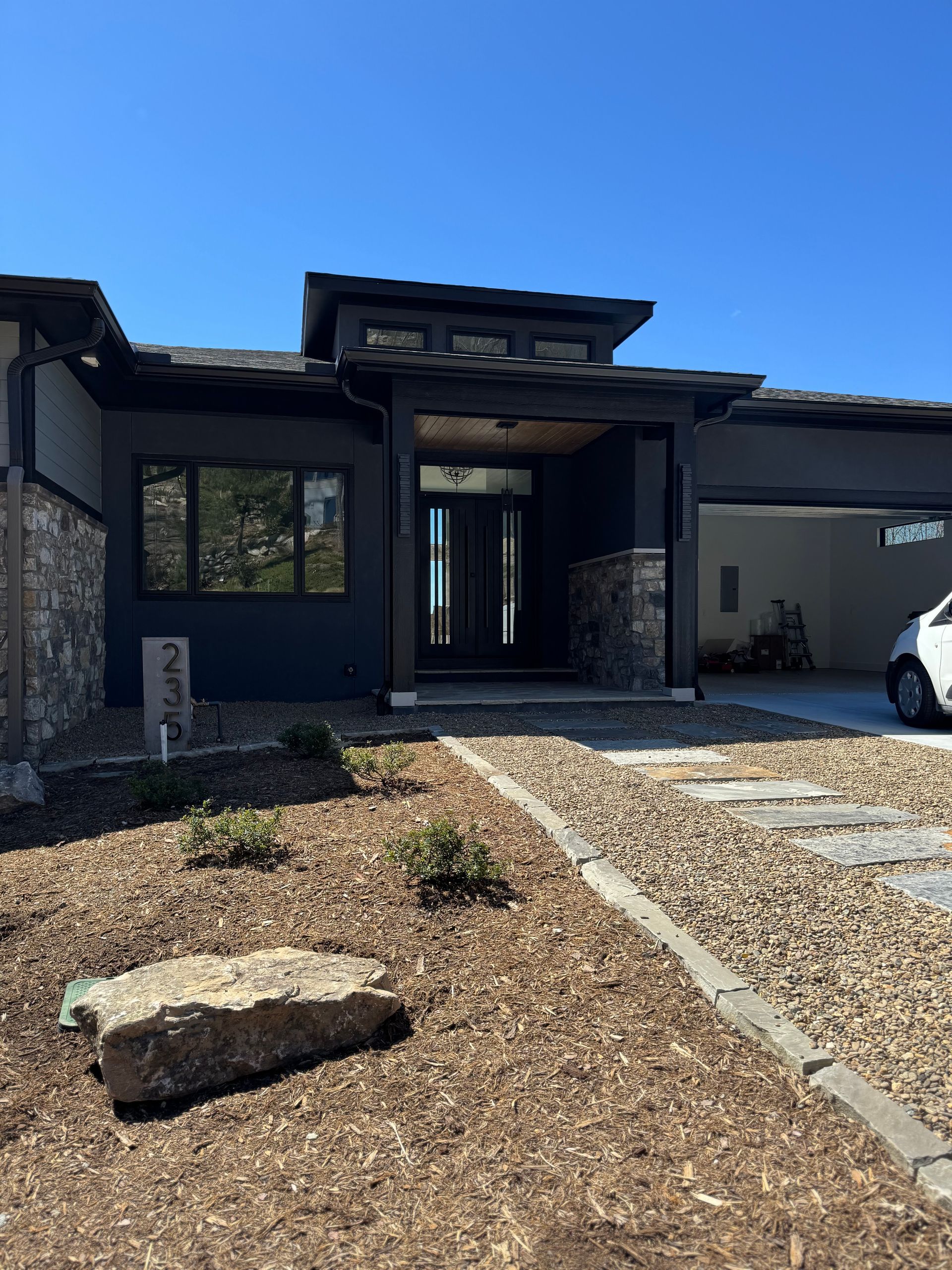 A large house with a car parked in front of it.
