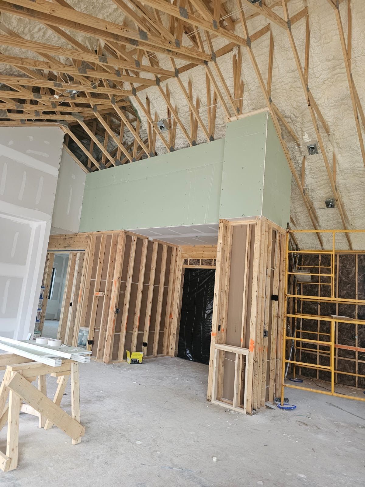 A large room with a ceiling that is being built