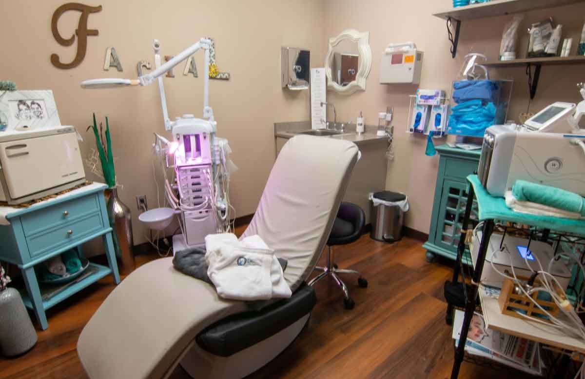 Dental or spa treatment room with chair, equipment, and turquoise accents.