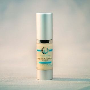Eye cream product bottle with silver cap and blue label.