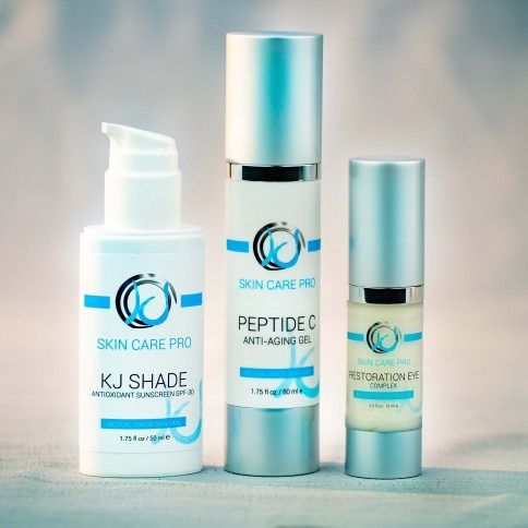 Three skincare product bottles: white and silver with blue accents.