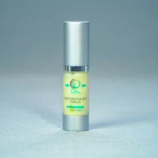 Eye cream bottle, silver and yellow, on a neutral background.