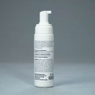 White pump bottle with product details on the label.