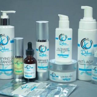 Skincare products in white and blue bottles, including cleansers, serums, and creams.