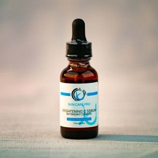 Bottle of Skin Care Pro Brightening C Serum with a dropper.