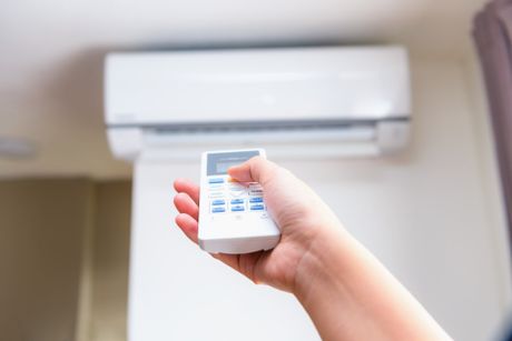 Cooling Services — Hand Operating Air Conditioner Remote Control in Greenwood, SC