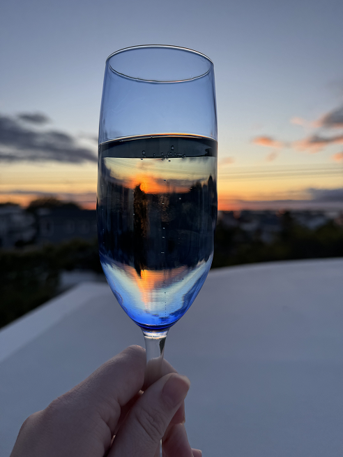 Wine glass catching the colors of a sunset