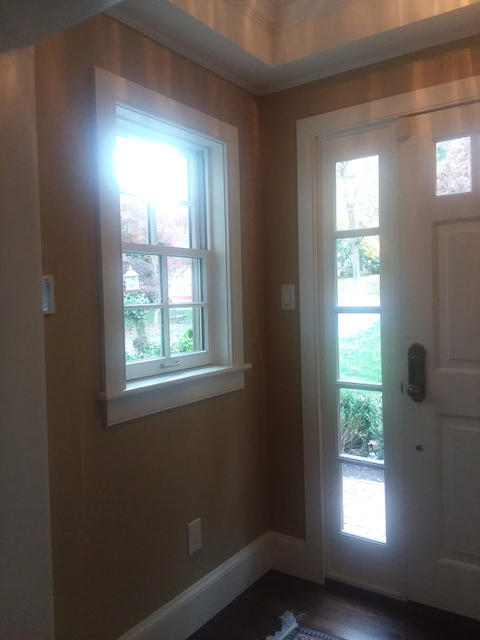 A hallway with a window and a door