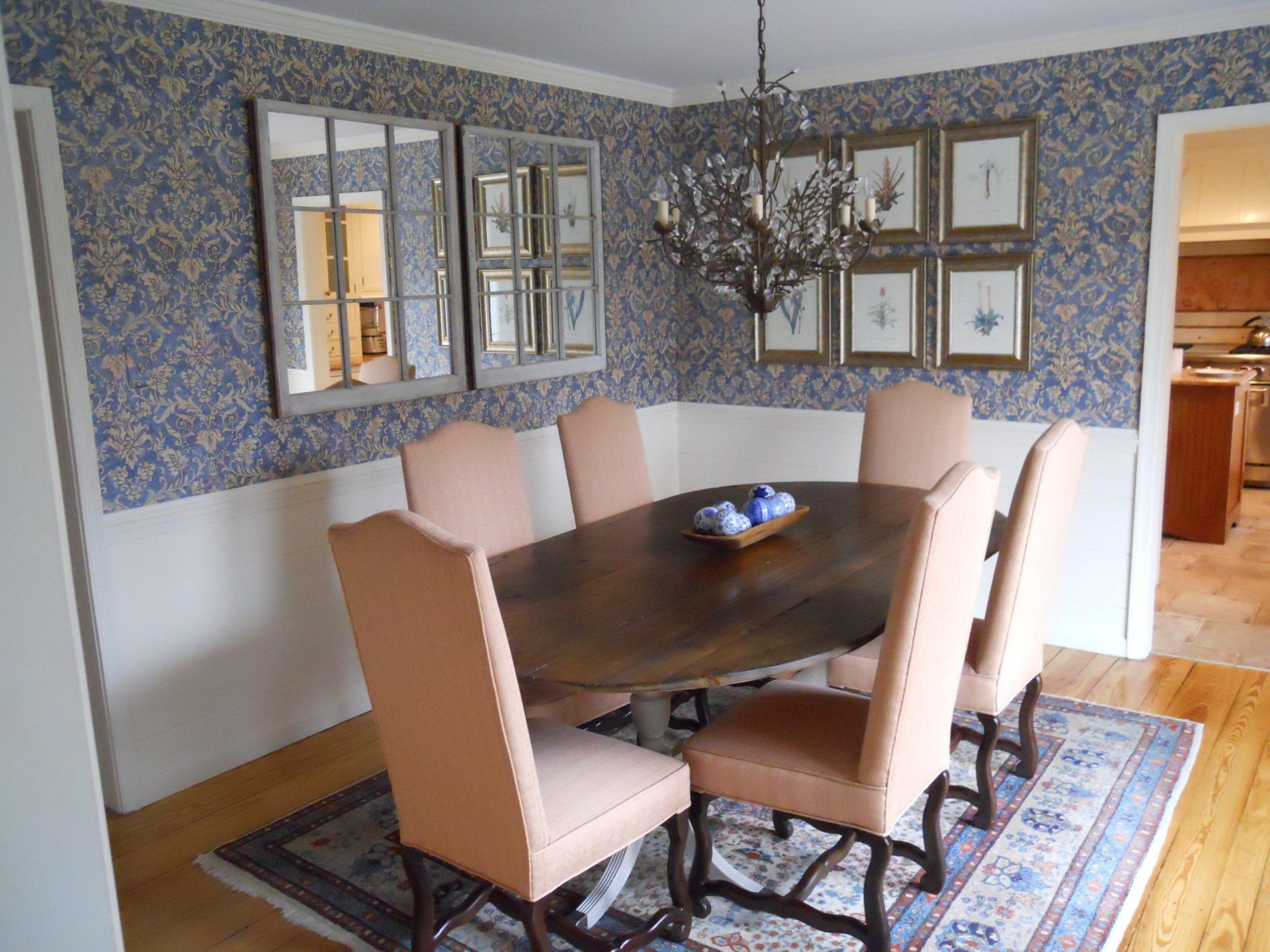 A dining room with a table and chairs and a chandelier