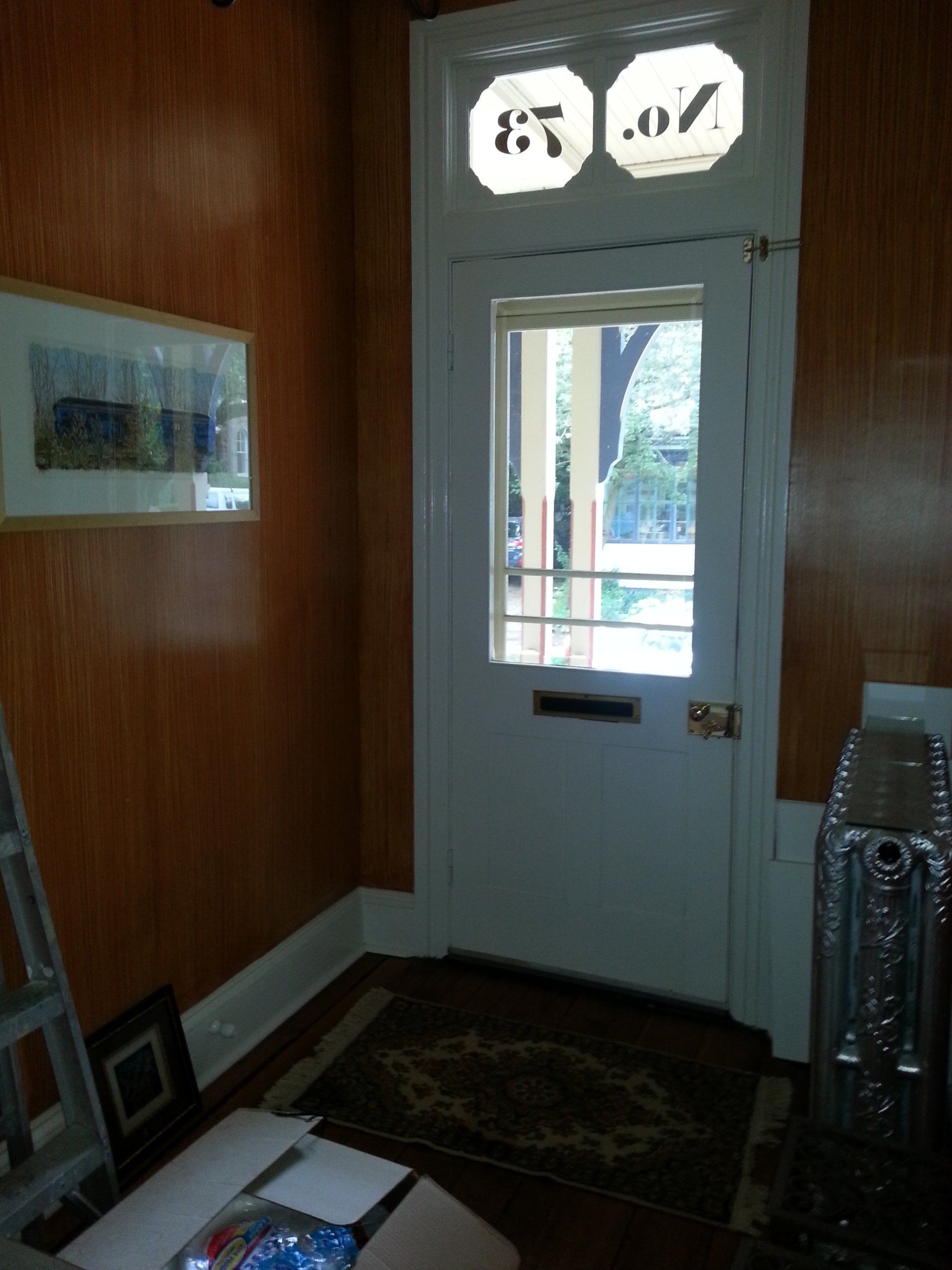 A room with a door and a window with the number 67 on it