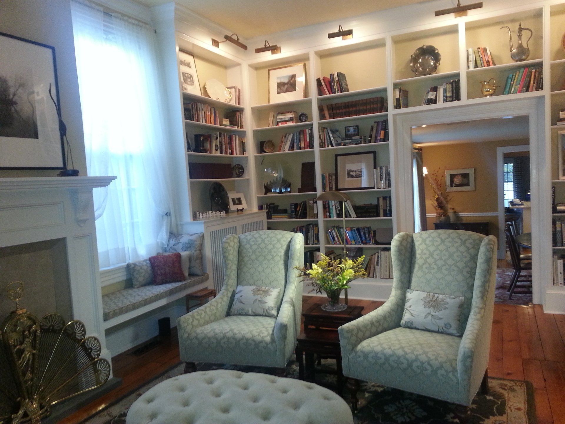 A living room with two chairs and a fireplace