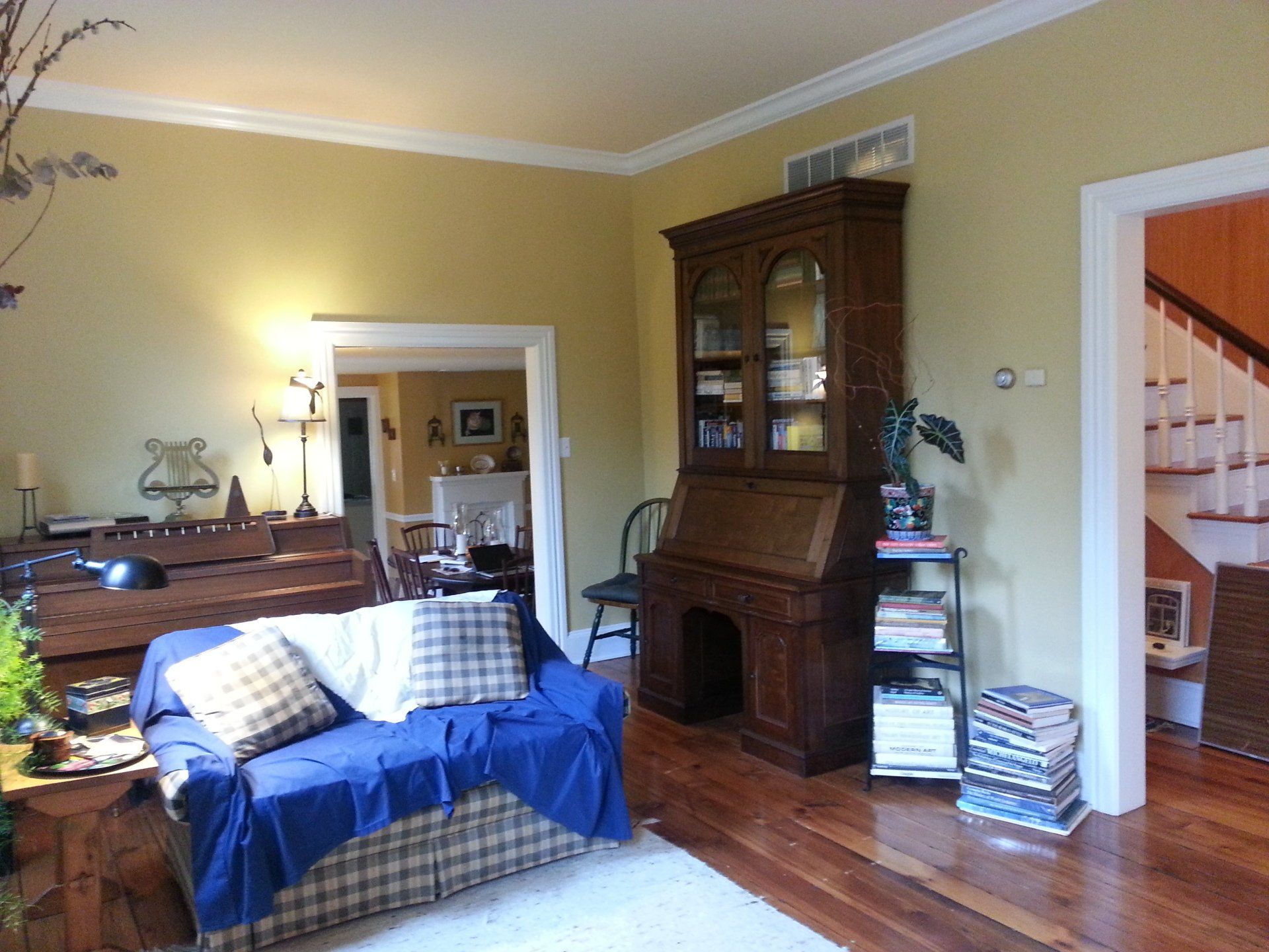 A living room with a blue couch and a bookcase