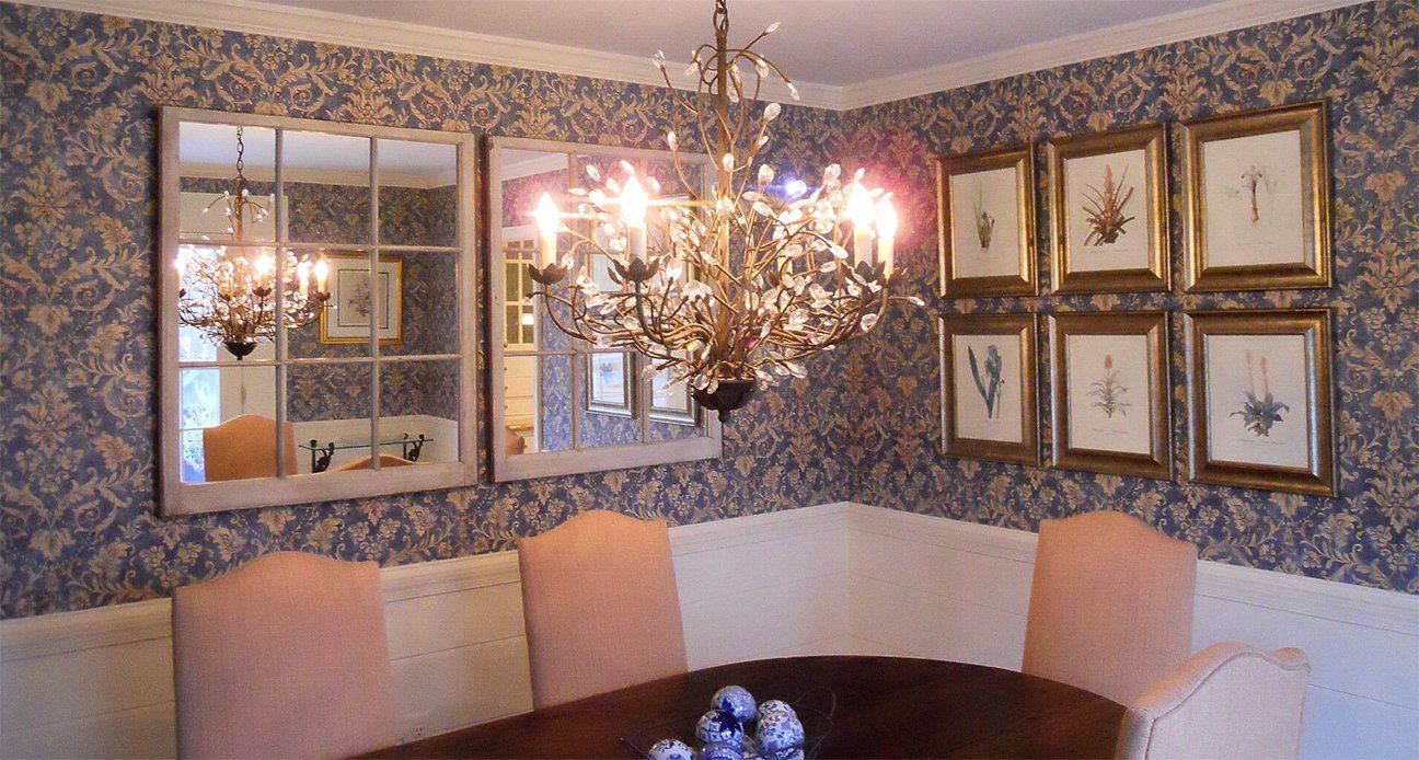 A dining room with a table and chairs and a chandelier