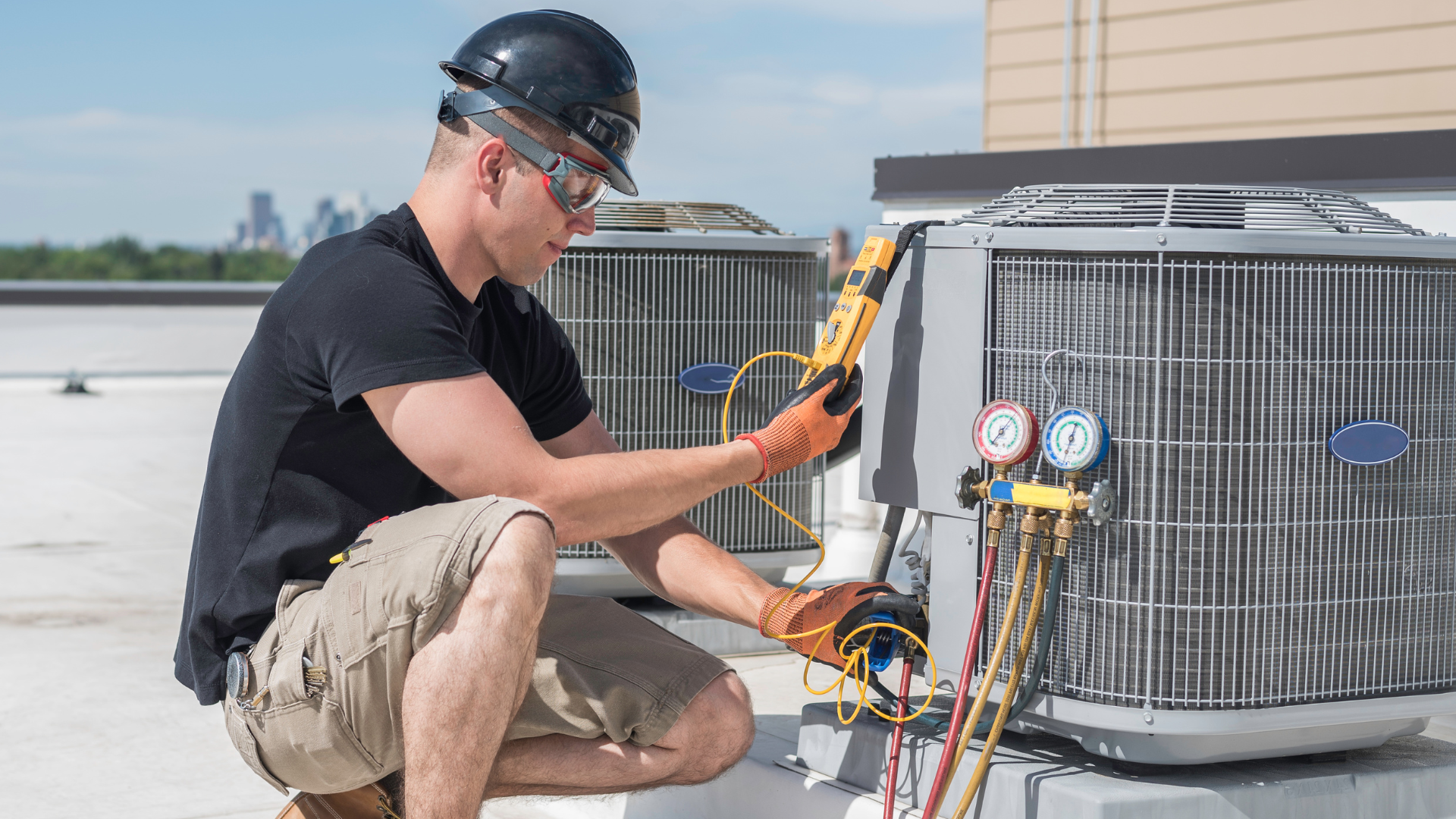 HVAC technician on a rooftop, inspecting an air conditioning unit with gauges.