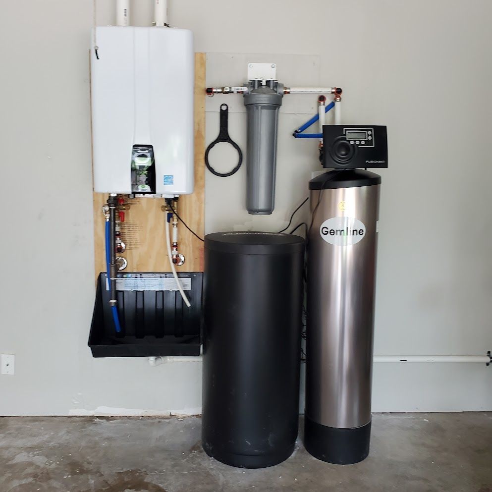 A stainless steel water filter is next to a black tank