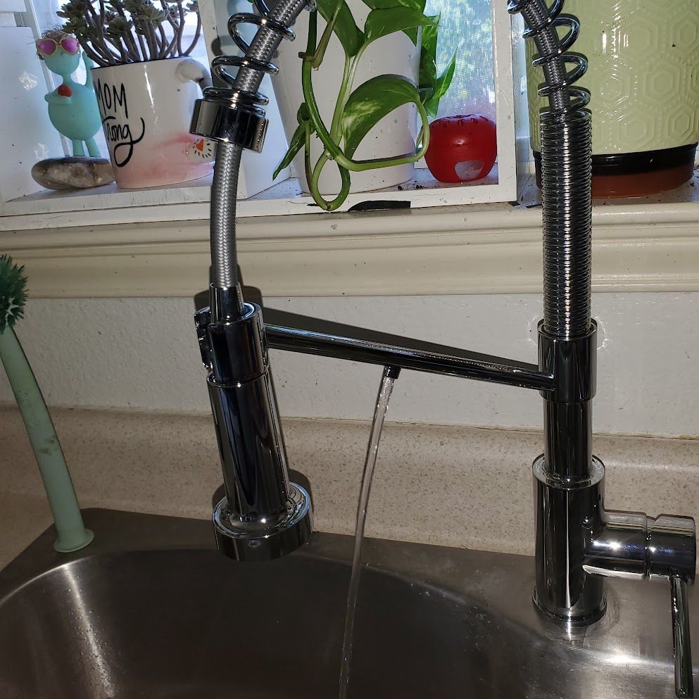 A kitchen sink with a faucet that says i love you on it
