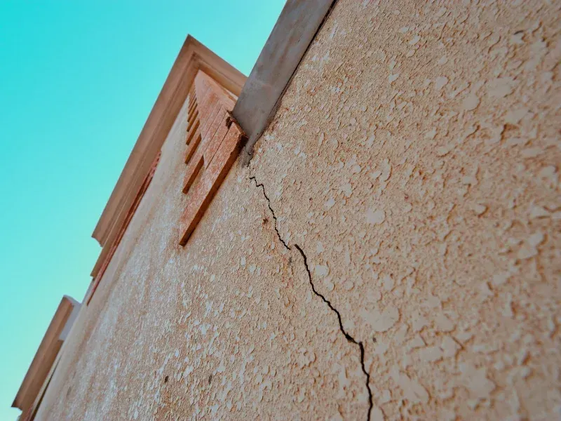 An image showing signs of foundation problems in a home, such as wall cracks and sticking doors.