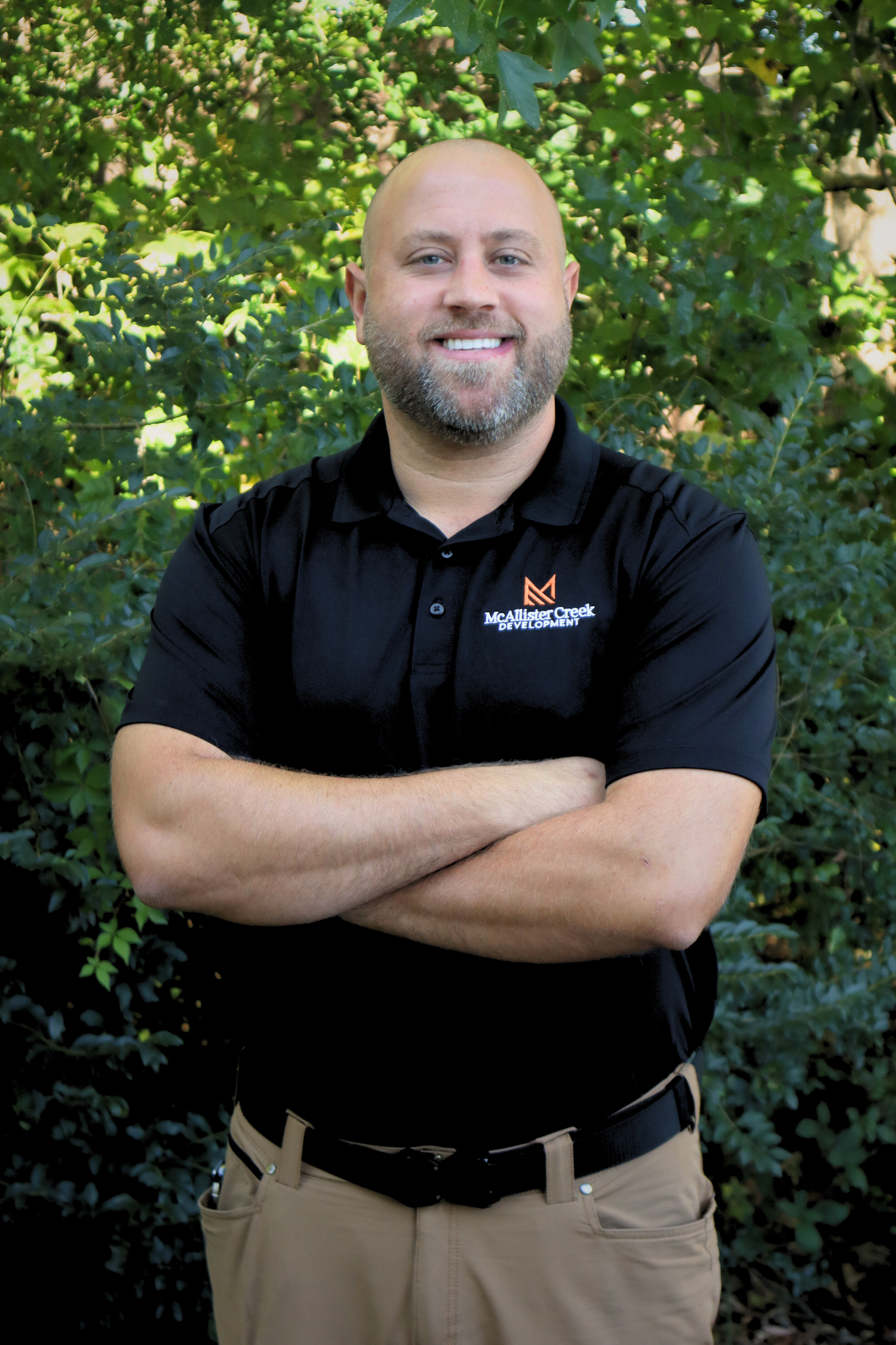 project manager smiling with arms crossed