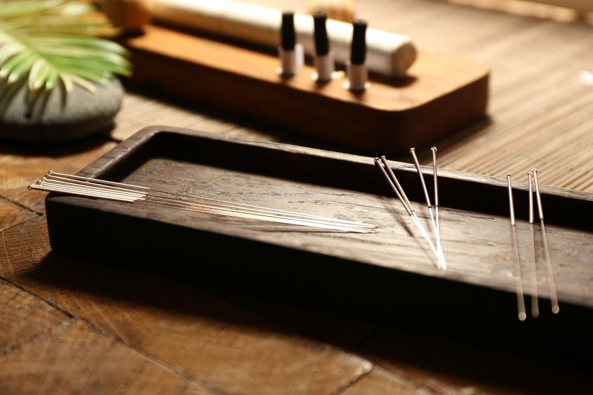A Wooden Tray Filled With Acupuncture Needles on a Wooden Table — Scott Martin Acupuncture Mackay In Mount Pleasant, QLD