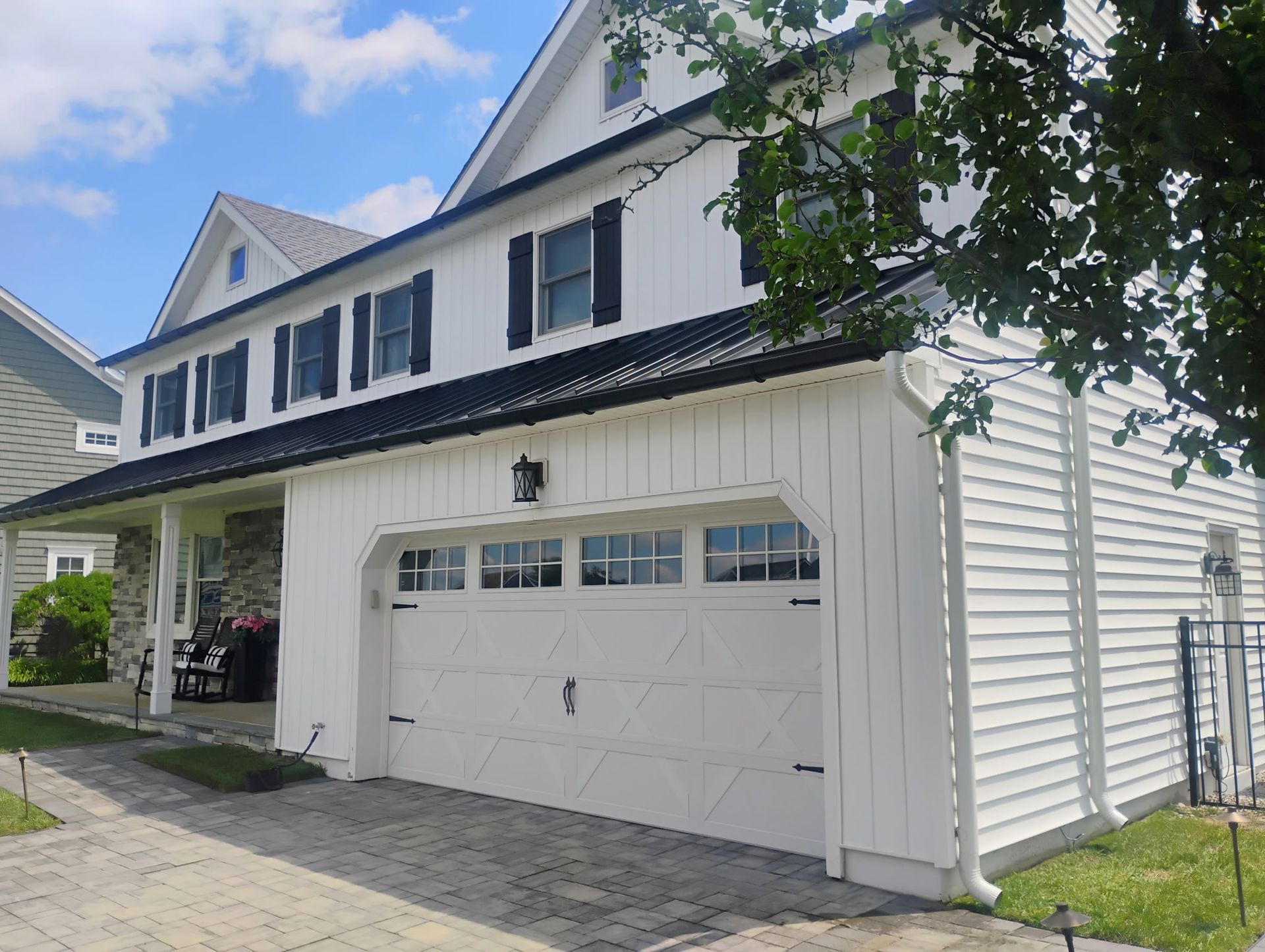White two-story home with black shutters and updated exterior featured in our project gallery.
