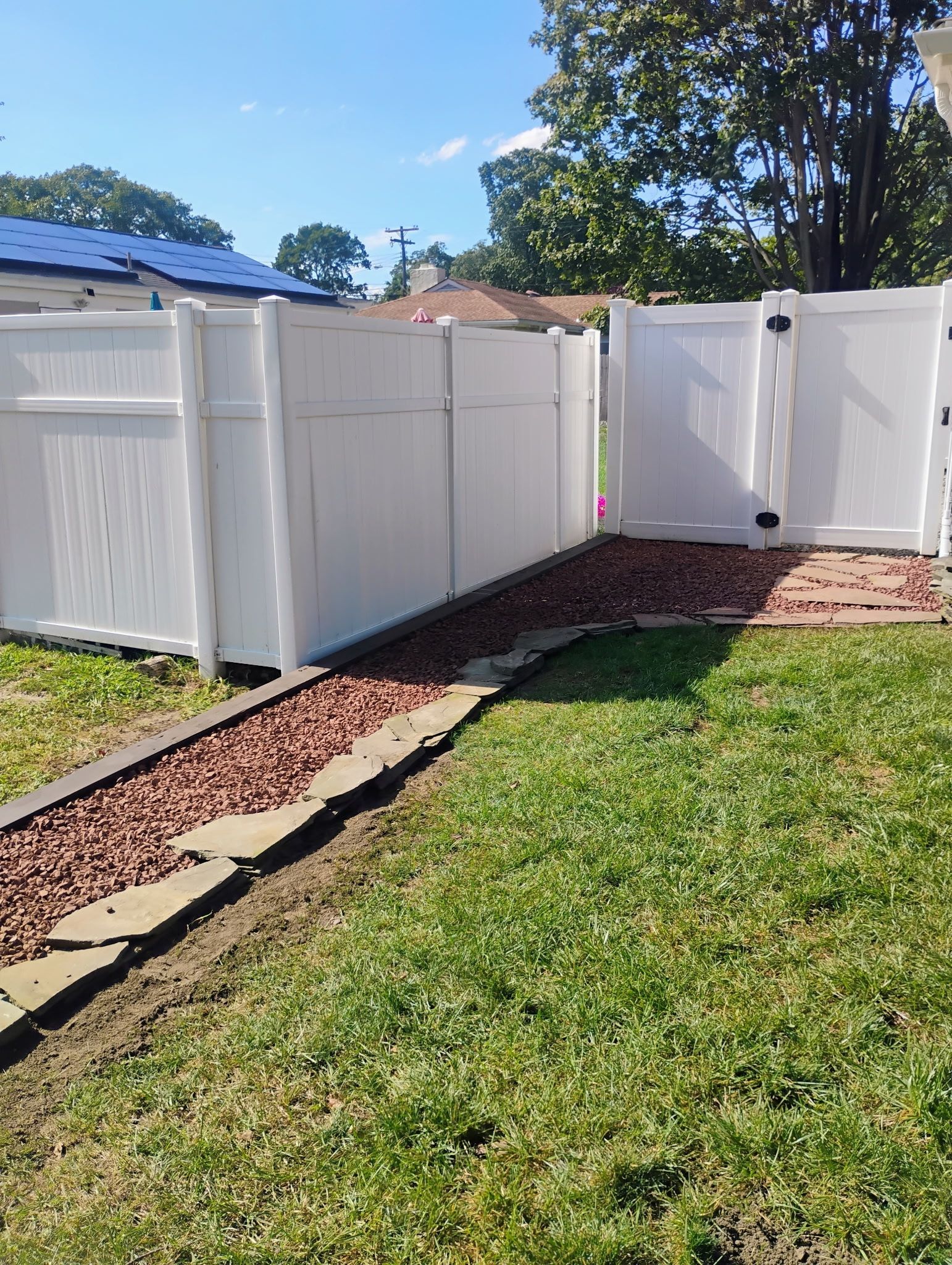 White vinyl fence and gate installation providing added privacy and clean exterior finish.
