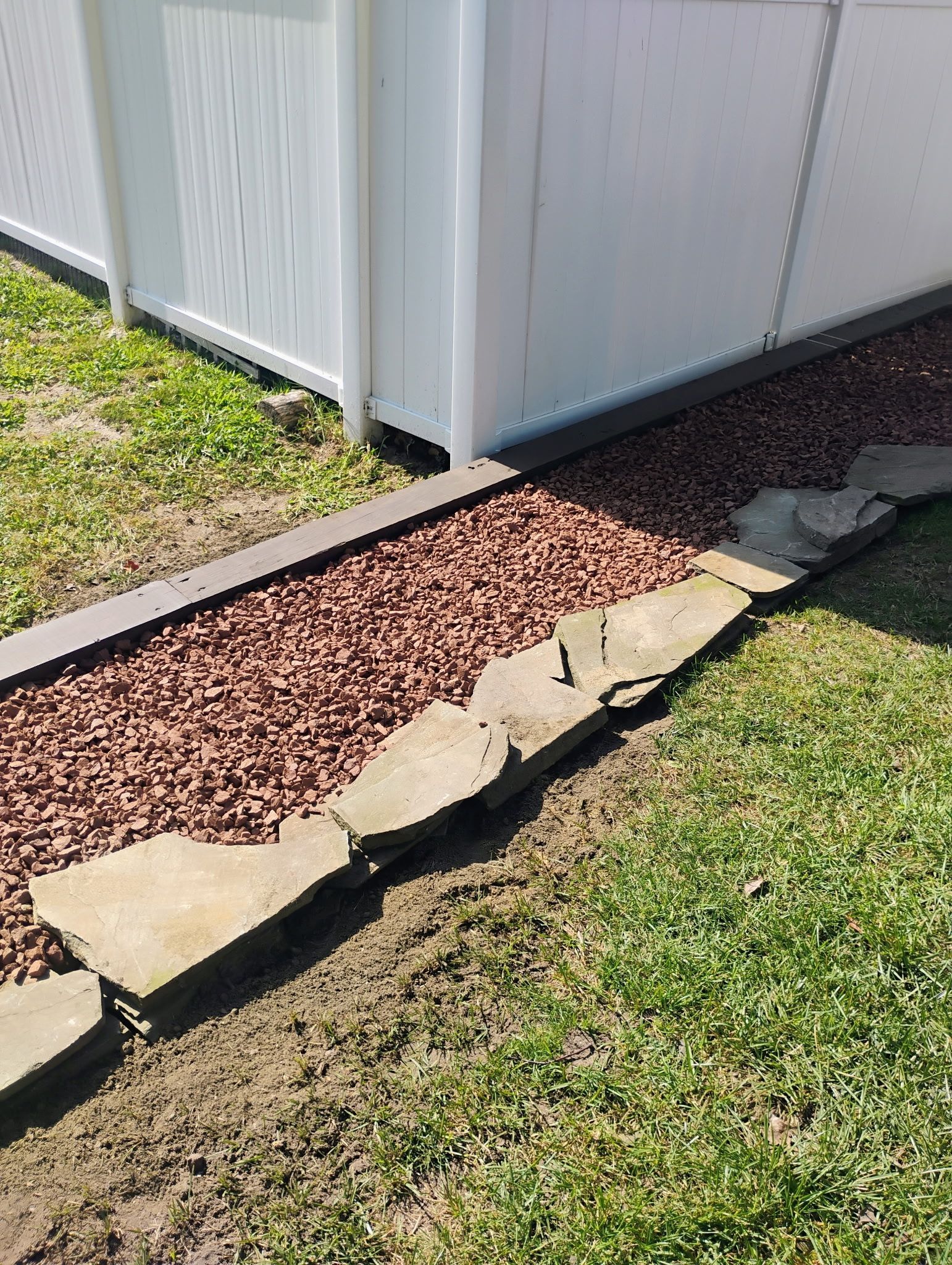 Vinyl fence installation with clean base and landscaping shown in our exterior project gallery.
