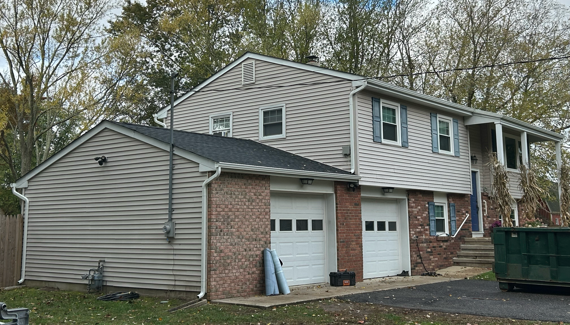 Two-story residential home with new roof and gutter system featured in our project gallery.
