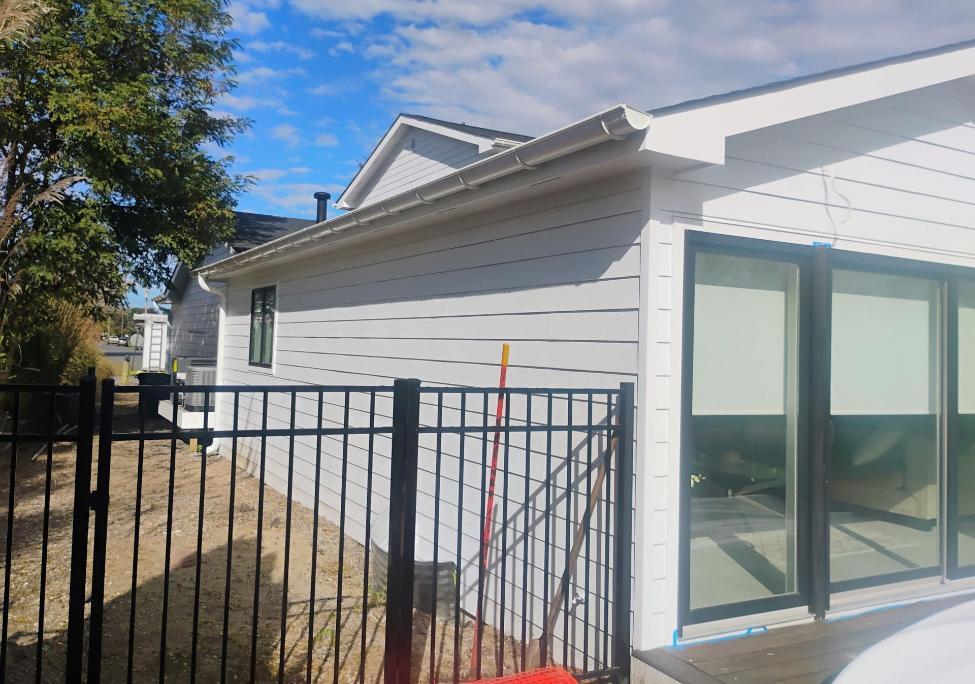 White home exterior with new siding and fencing included in our completed project gallery.
