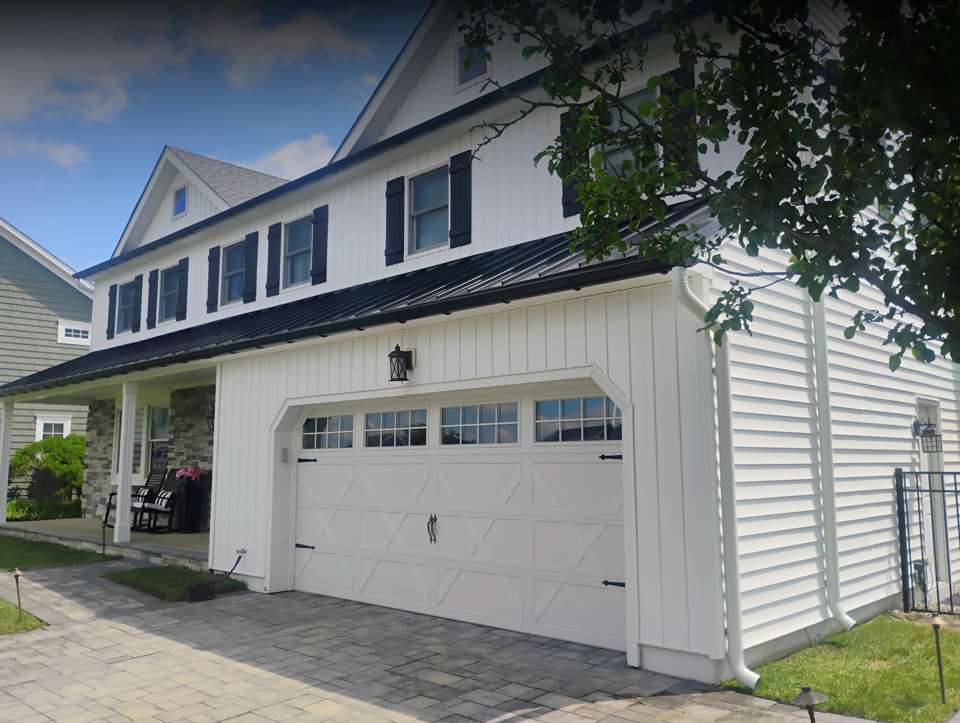 White residential home with updated roofing and exterior work featured in our gallery.

