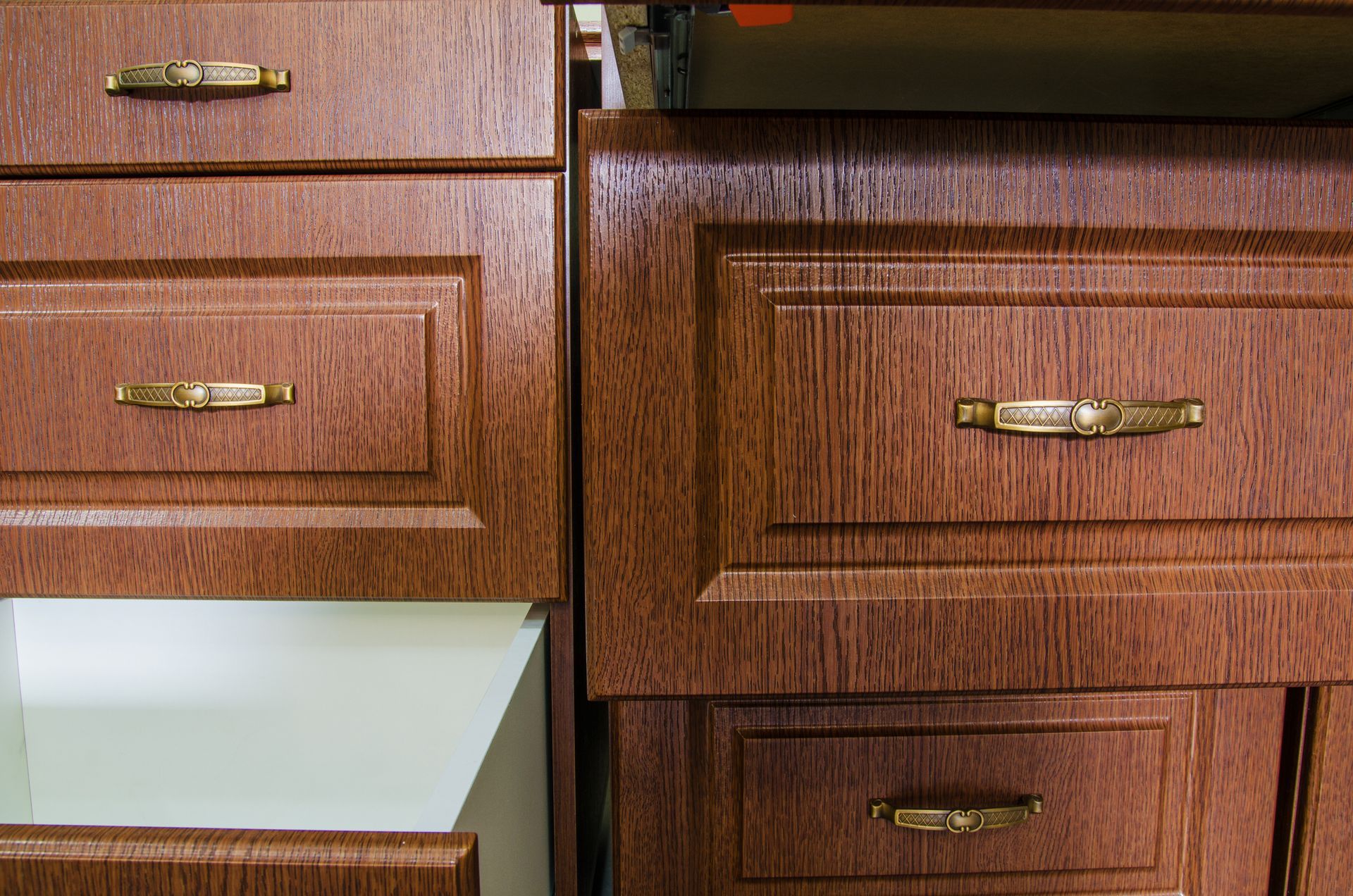 A close up of a wooden cabinet with a drawer open