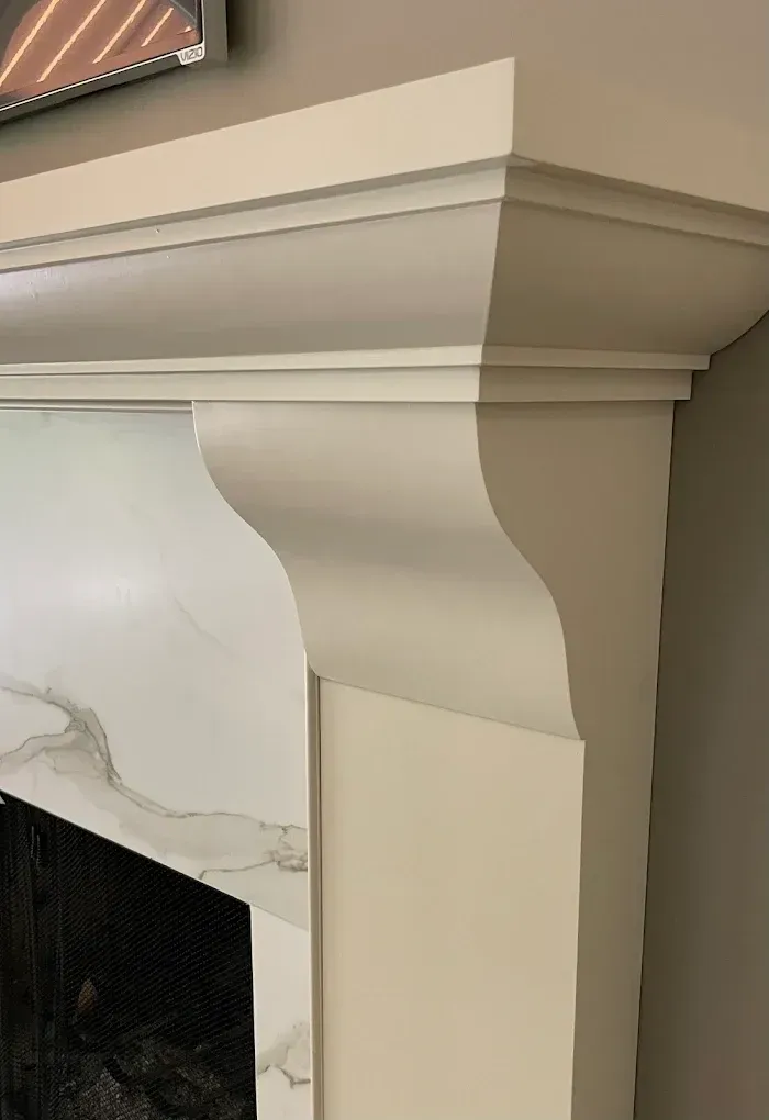 white mantel on stone fireplace
