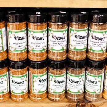 A shelf filled with lots of jars of spices.