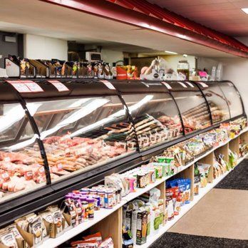 A butcher shop filled with lots of meat and groceries.