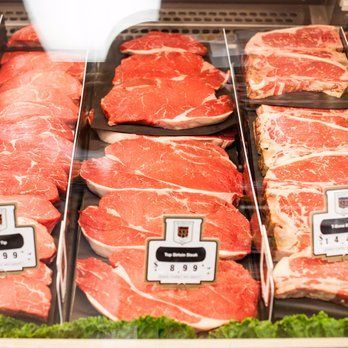 A display case filled with lots of different types of meat.