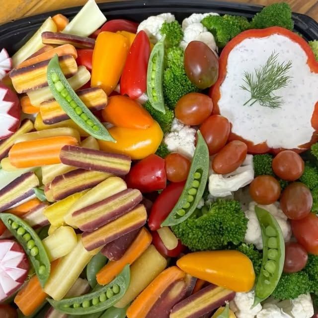 A tray of vegetables with a sauce on top