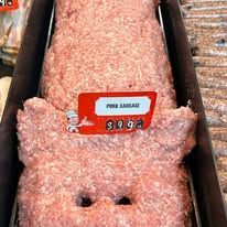 A tray of ground pork in the shape of a pig.