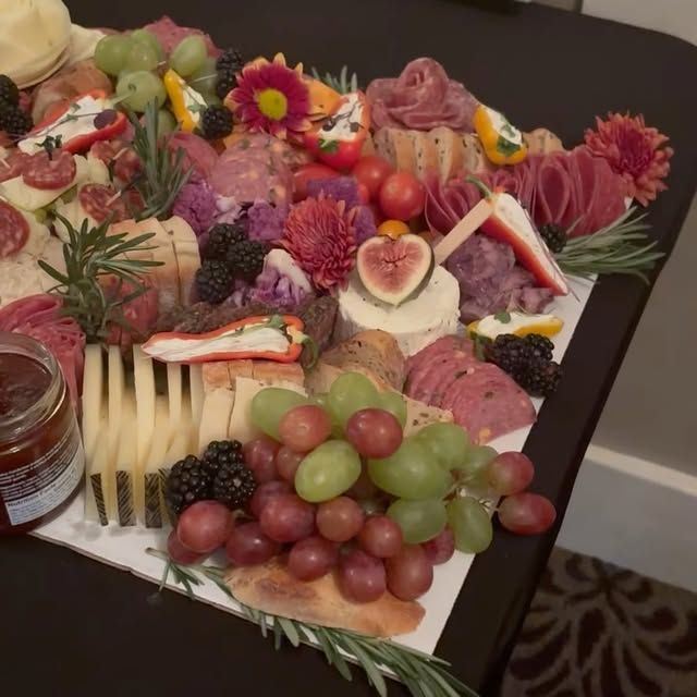 A tray of fruits and meats on a table