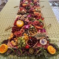 A long table topped with a variety of fruits and vegetables.
