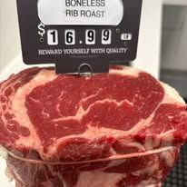 A close up of a steak with a price tag on it.