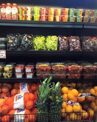 A variety of fruits and vegetables are on display in a grocery store