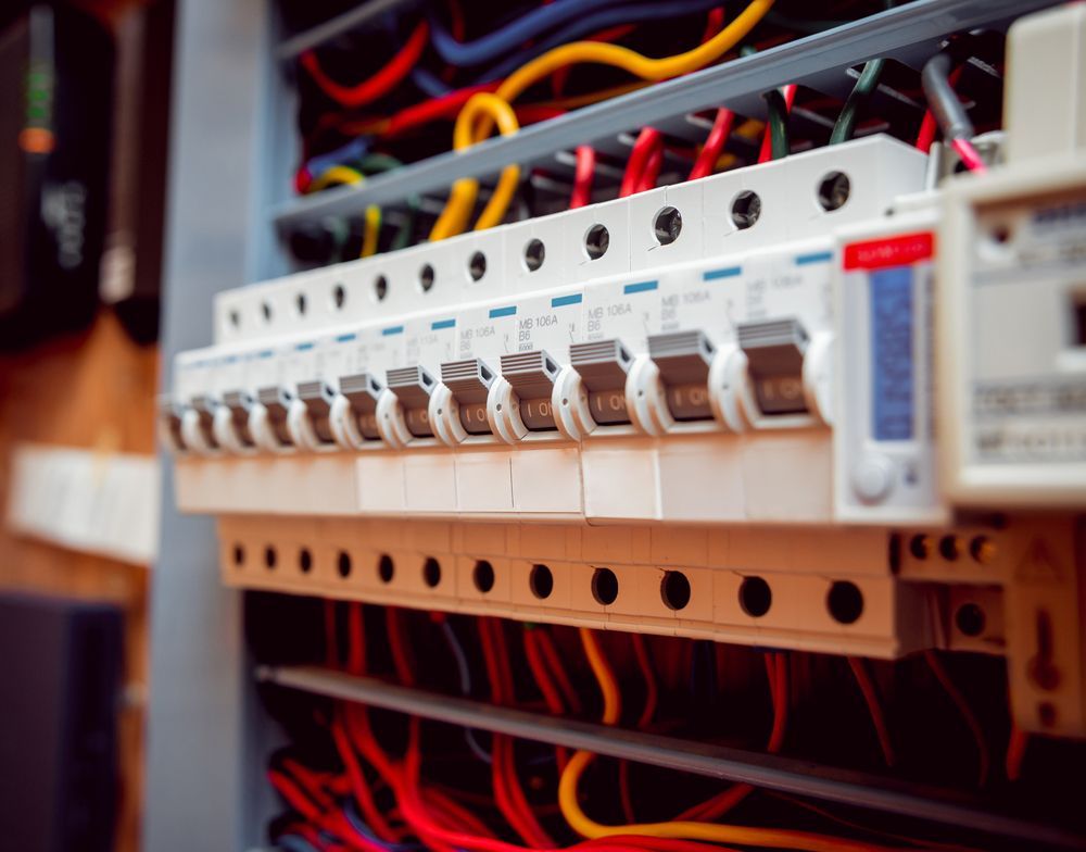 Electrical Panel With Rows of Circuit Breakers and Colorful Wires — DC Active Electrical in Bracken Ridge, QLD