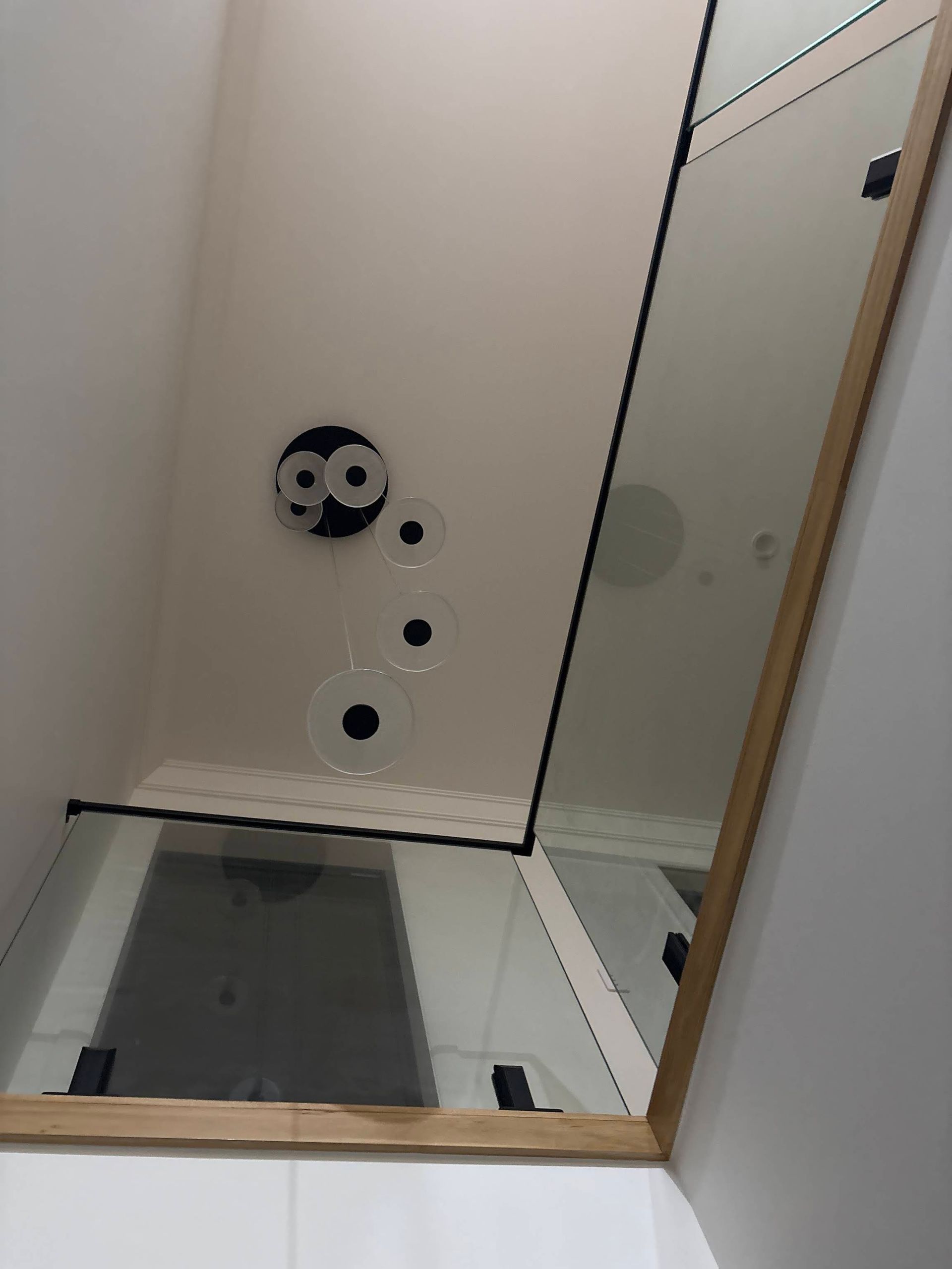 Mirror Reflecting a Room With Black Fixtures, Circular Wall Art — DC Active Electrical in Brighton, QLD